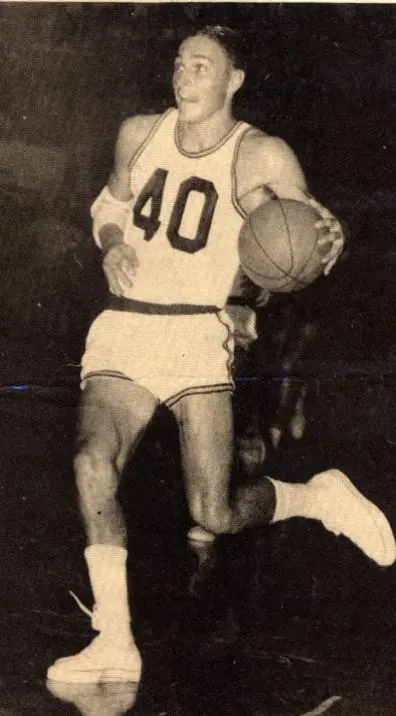 Bill James, No. 40, dribbling up the floor in a white Scottsburg uniform