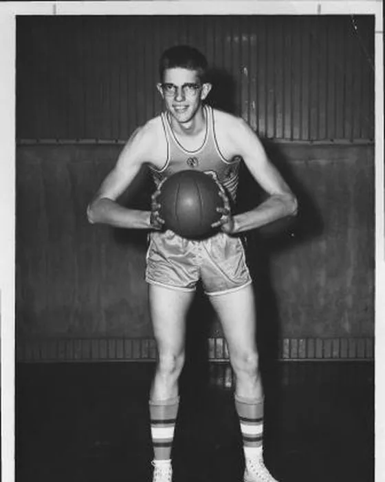 Vern Altemeyer as a Scottsburg player, holding a basketball in a gym