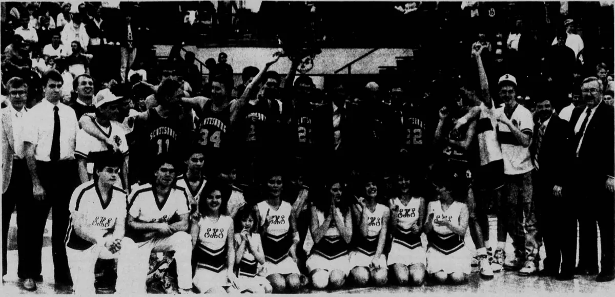 Newspaper photo: Scottsburg's players, cheerleaders and coaches crowded together on the floor, arms raised, a player holding up the net