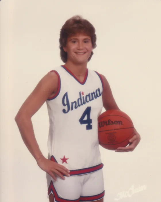 Sheryl Bonsett in her Indiana All-Stars No. 4 uniform, holding a basketball