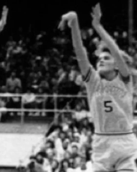 Carla Westmoreland, No. 5, shooting a jump shot in a white Warriorettes uniform