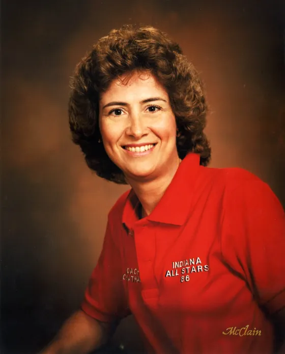 Donna Cheatham smiling in a red Indiana All-Stars ’86 coach's shirt