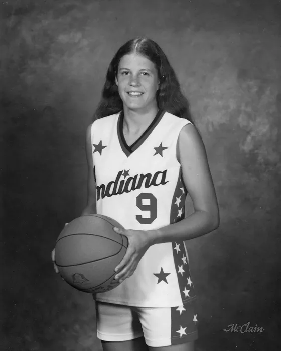 Cindy Piet in her Indiana All-Stars No. 9 uniform, holding a basketball