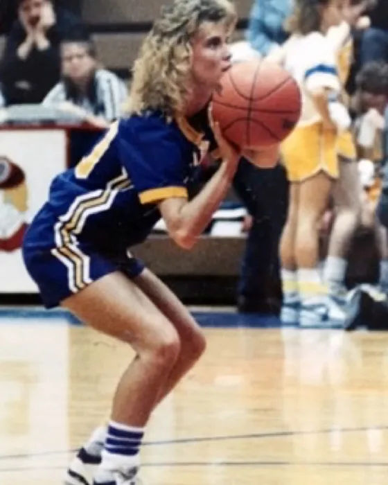 Carrie Thompson shooting in a Warriorettes uniform