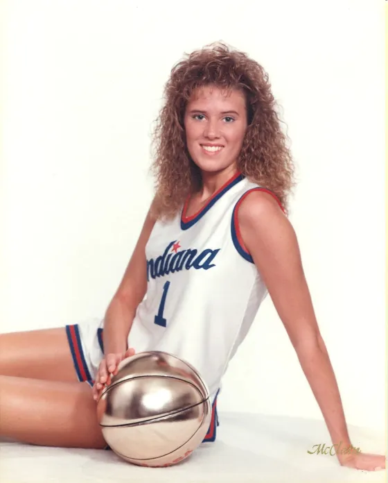 Renee Westmoreland in her Indiana All-Stars No. 1 jersey, sitting beside a gold basketball